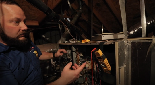 technician inspecting furnace